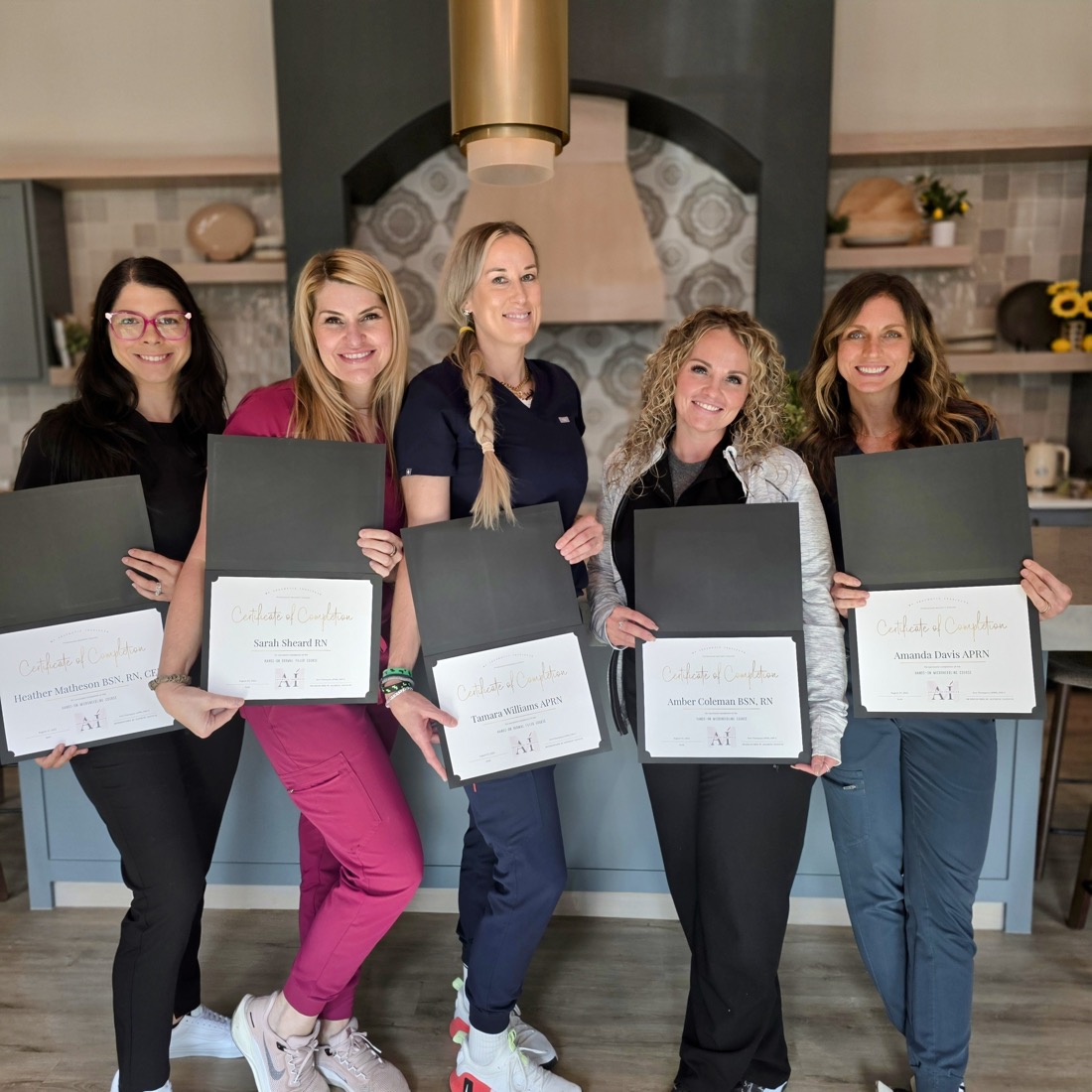 Graduates of My Aesthetic Institute holding their Certificates of Completion